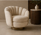 Ribbed Shell ivory bouclé lounge chair with rounded channelled back and sculptural compact profile in a warm interior.