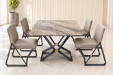 The Kinetic four-seater marble dining set with a grey veined top, interlocking graphite metal base, gold accents and four greige upholstered chairs. Four-seater marble dining table set in Pakistan featuring a grey veined marble top, modern graphite metal frame, gold accents and four comfortable greige upholstered chairs by Z Galleria Lahore.