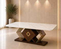 A modern rectangular dining table with a white marble-look top and a geometric dark wood and gold metal base, shown in a styled interior room with a slatted beige wall and floor.