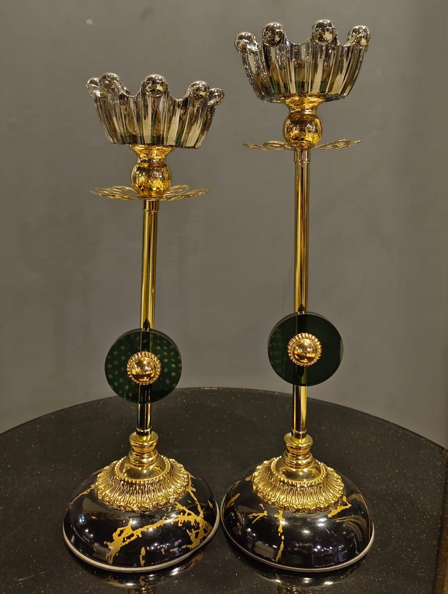 Black and gold candle stand set styled on a console table