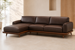 The Lorenzo Leather Lounge in dark brown leather, featuring a left-facing chaise, rounded stitched armrests, deep cushions, and a walnut-toned wooden base.