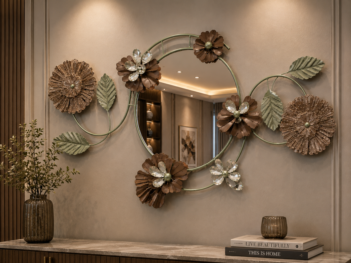 Sage Bloom decorative wall mirror with round mirror center, sage green leaves, brown flowers, beige floral accents, and crystal-style petals above a console table.