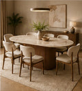 Elara oval 6-seater dining set in warm beige upholstery with a Sheesham wood ribbed base and light sintered stone top, hero three-quarter view.