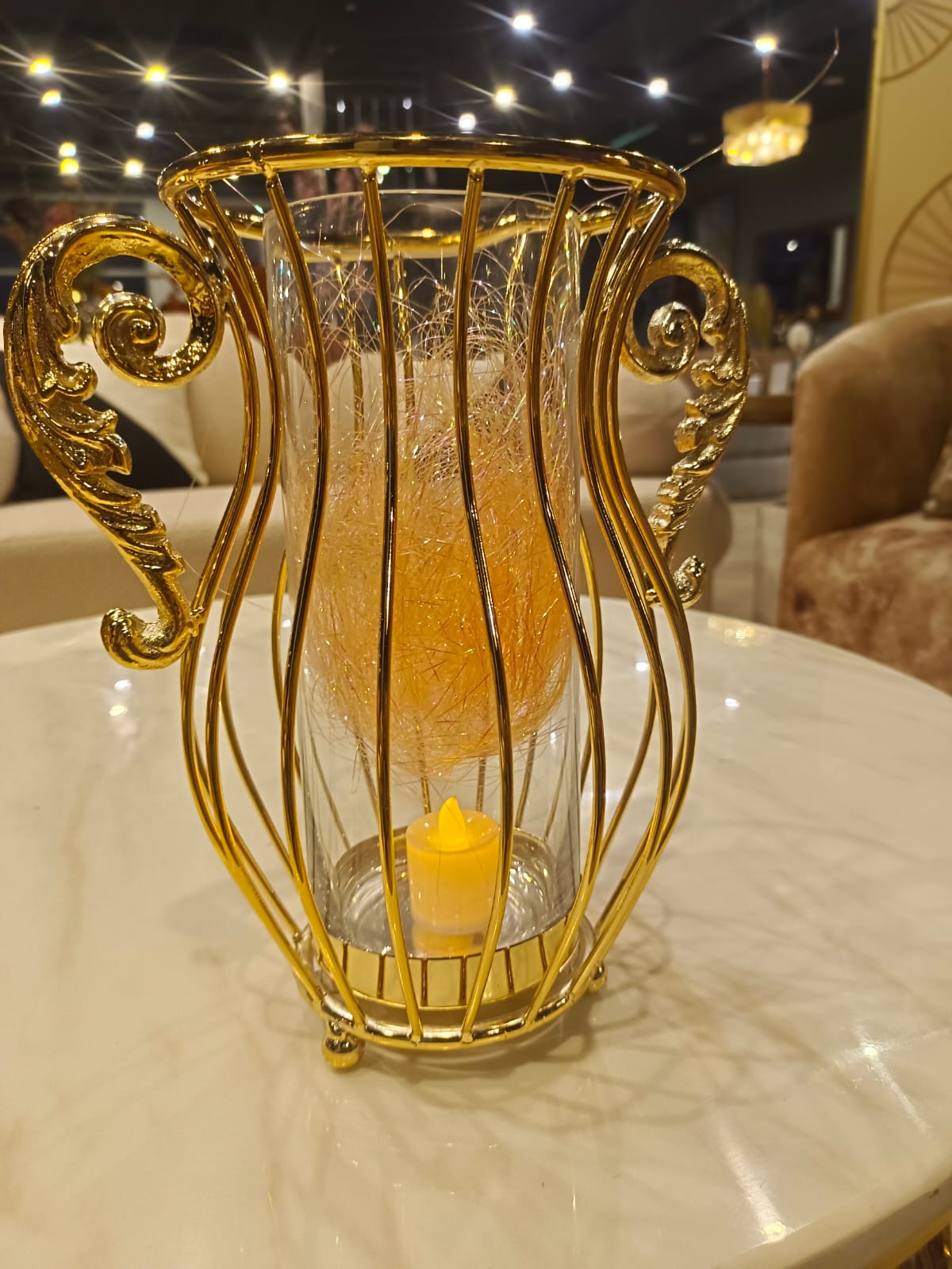 Gold stainless steel crystal vase styled on a shelf