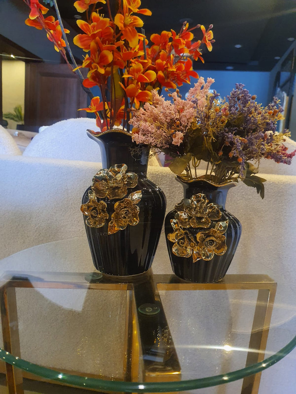 Black and gold ceramic vase set styled on a shelf