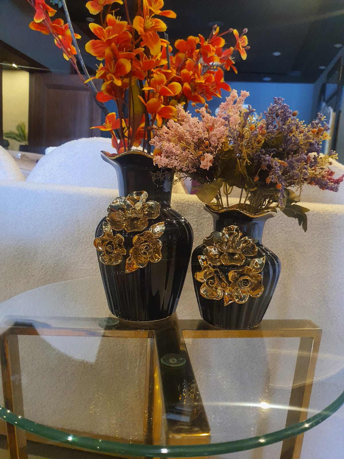 Black and gold ceramic vase set styled on a shelf