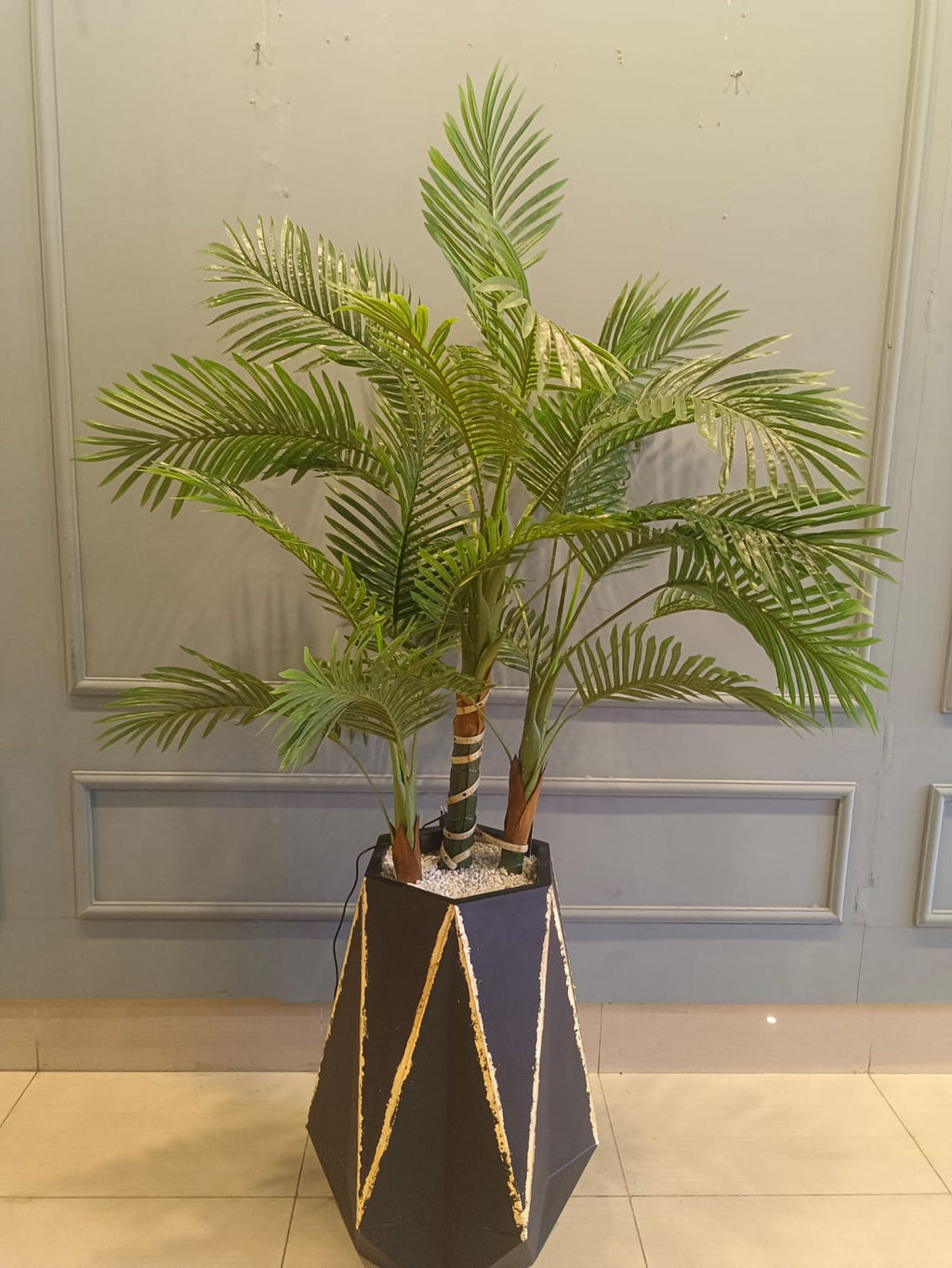 Artificial palm plant with planter detail view
