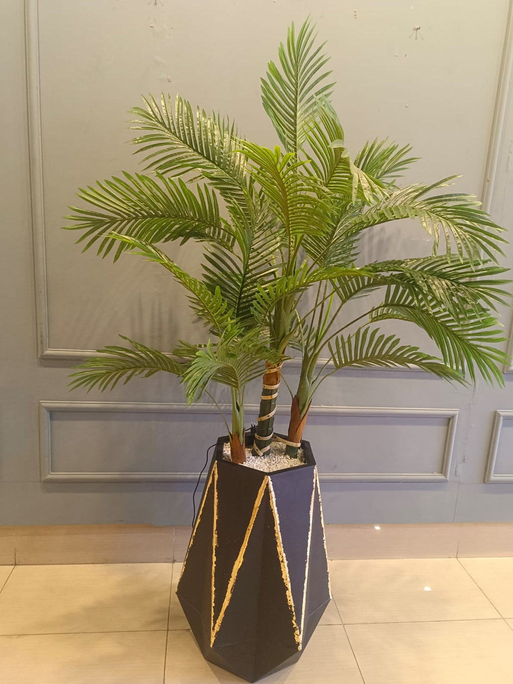 Artificial palm plant styled in a room