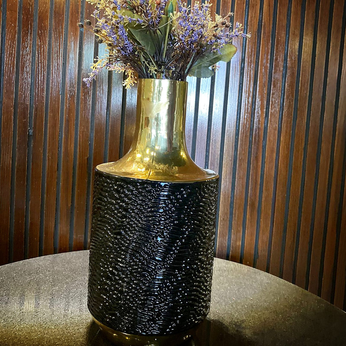 Vintage black and gold alligator vase styled on a console