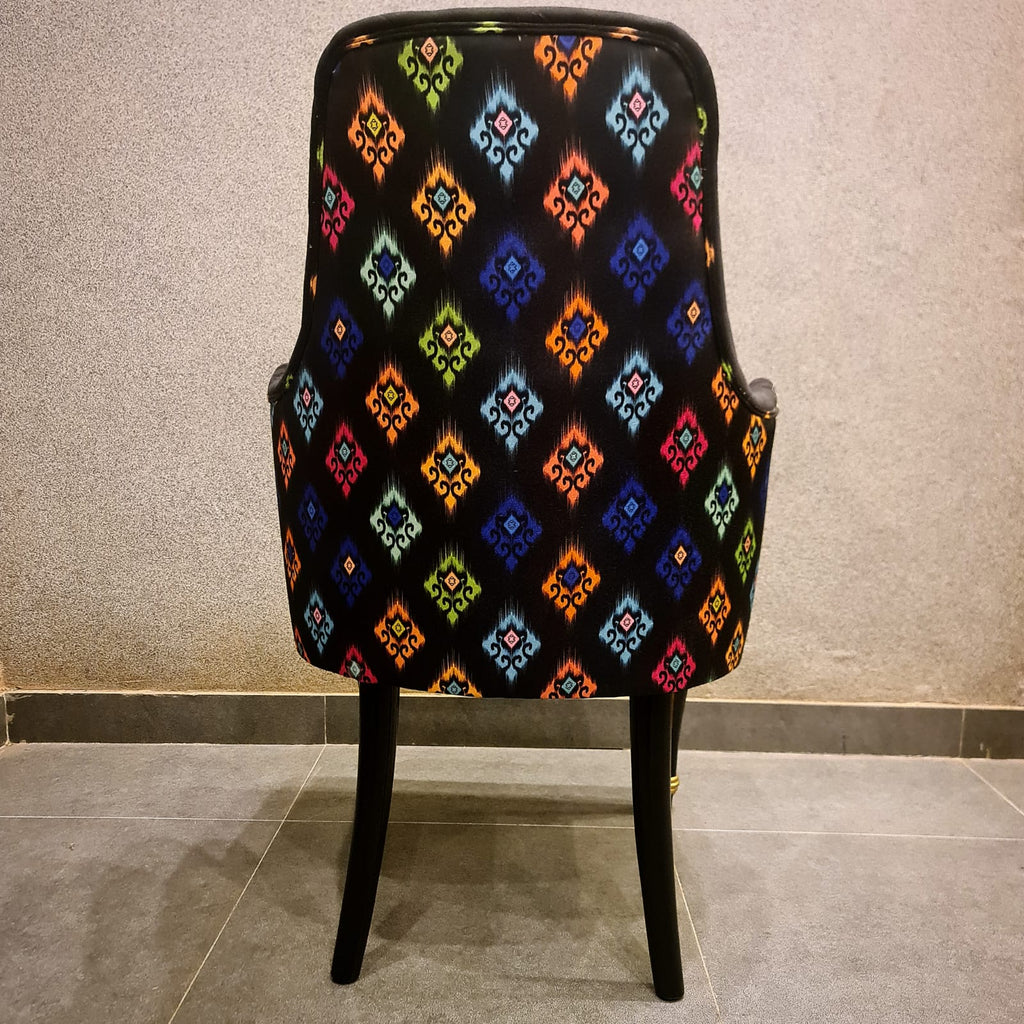 Modern black and gold dining chair styled in a dining room