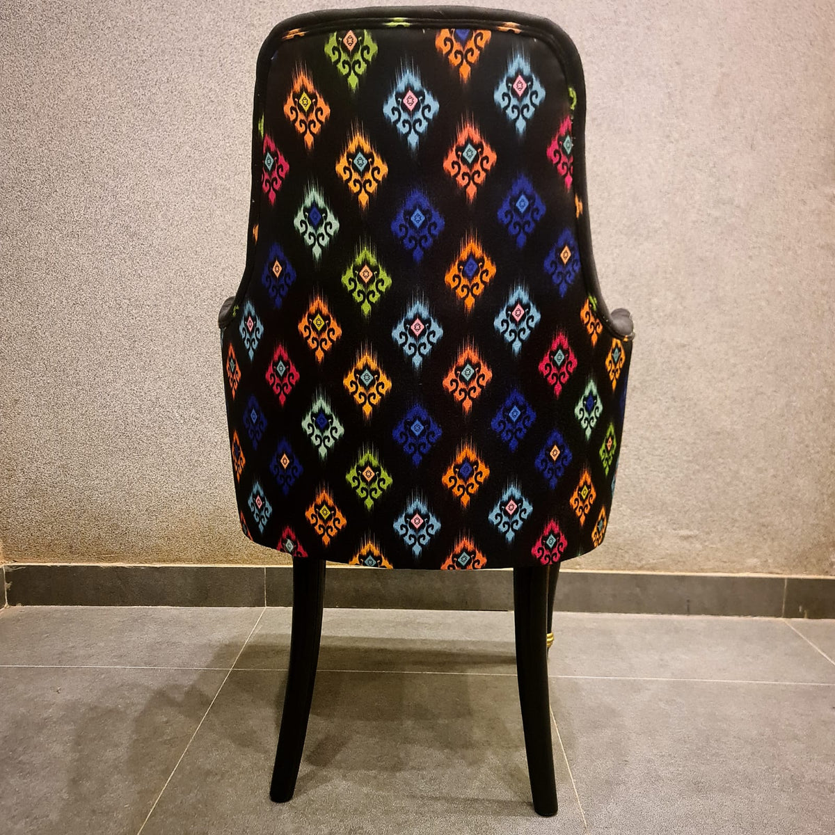 Modern black and gold dining chair styled in a dining room