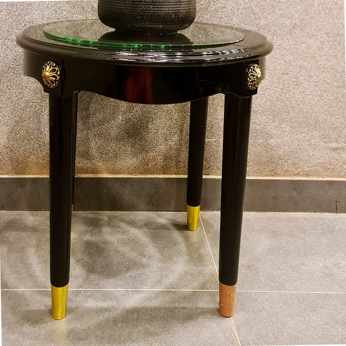 Round wooden coffee table with glass top detail view