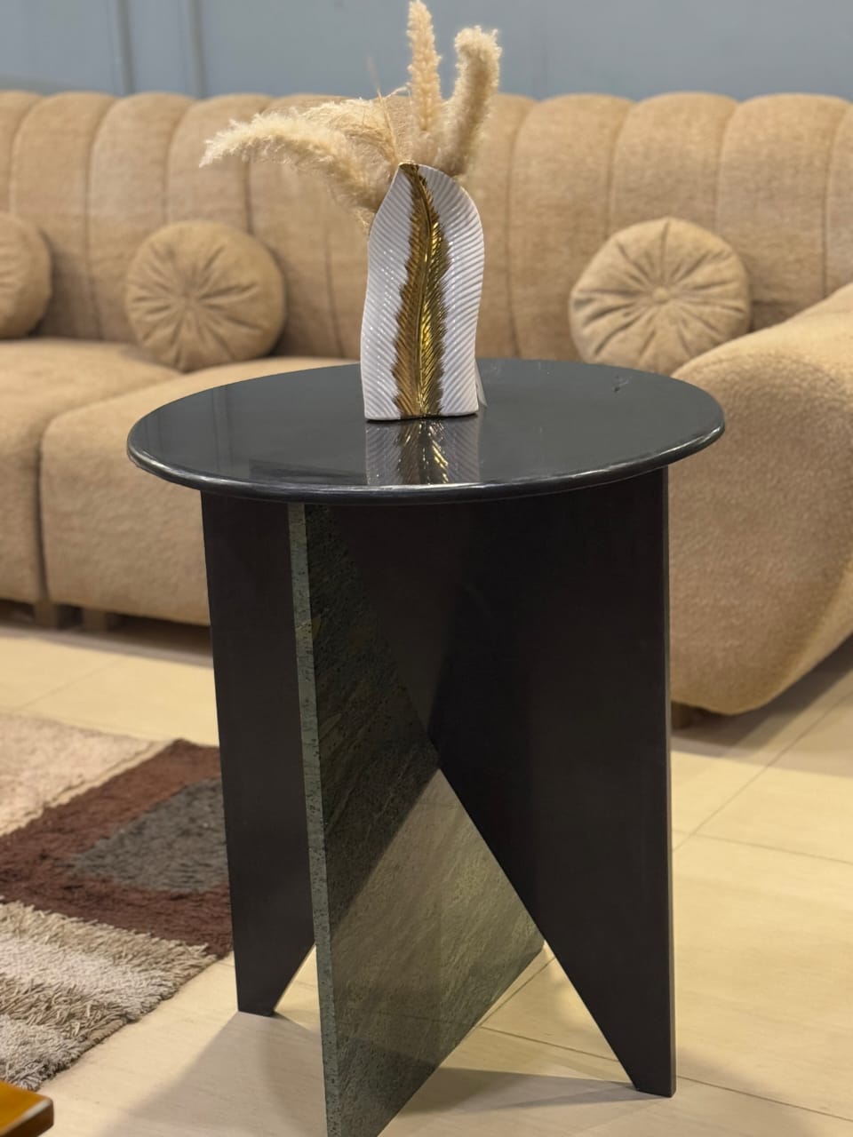Black marble coffee table styled in a living room by Z Galleria