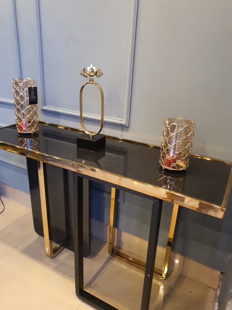 Gold marble console table styled in a room