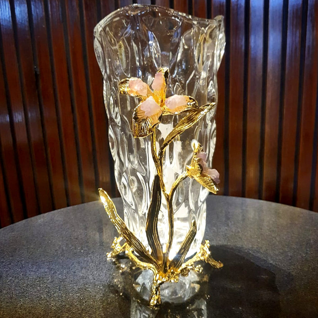 Glass vase with gold metal flower relief styled on a shelf