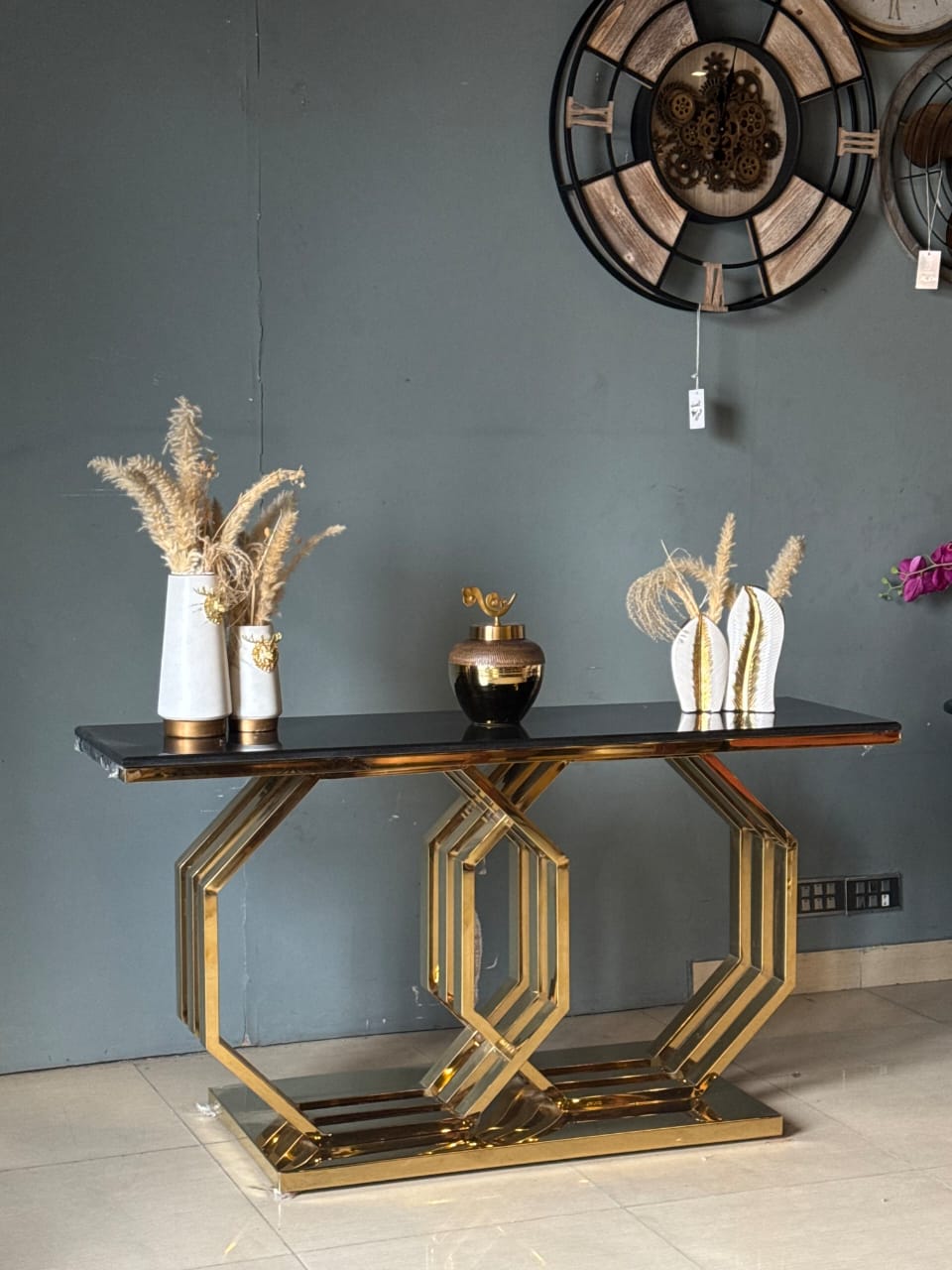 Premium black and gold console table styled in an entryway