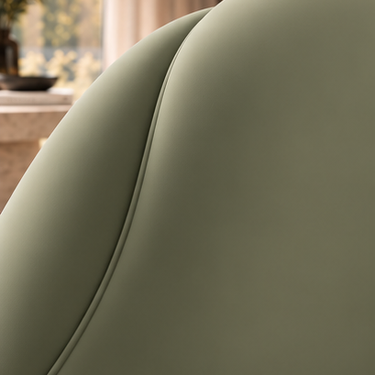 Close-up of smooth sage boucle upholstery and tailored seam detail on Aurelia Cocoon Lounge Chair