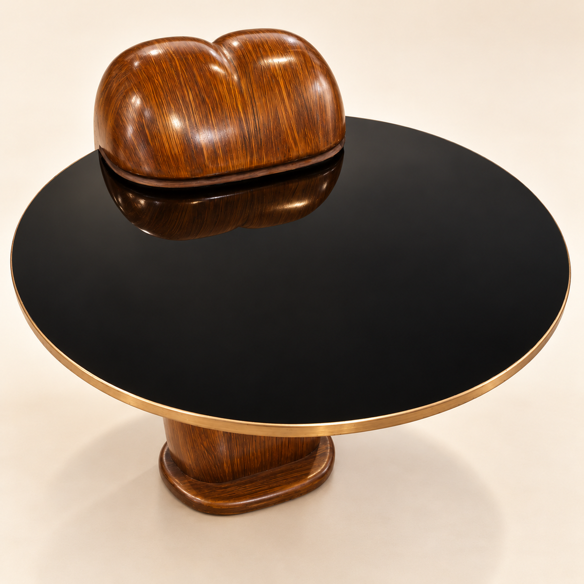 Elevated retouched view of the Aurum side table's round black glass top and gold-tone edge.