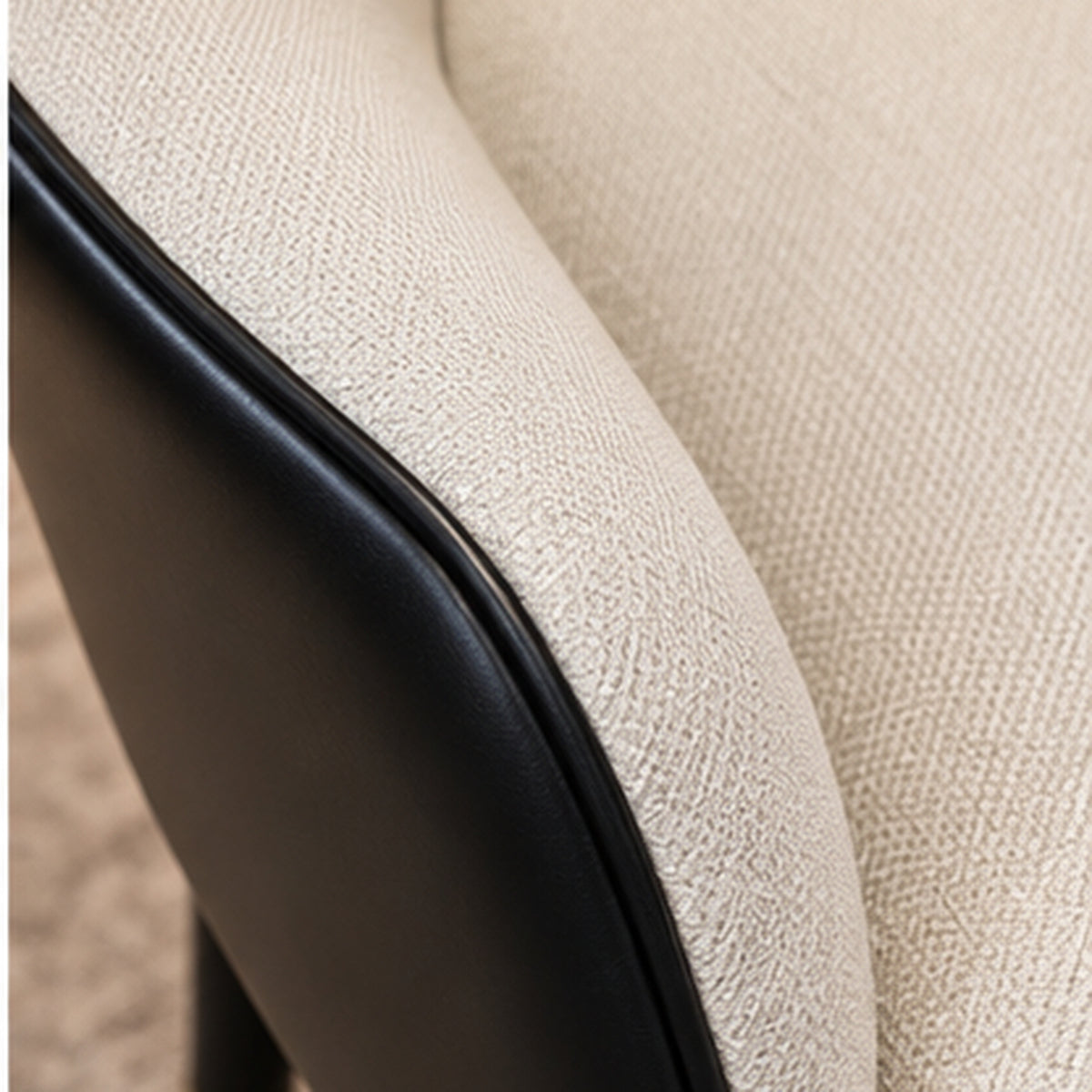 Designer Pleated-Back Accent Chair material close-up showing ivory upholstery, black leather-look shell and stitching