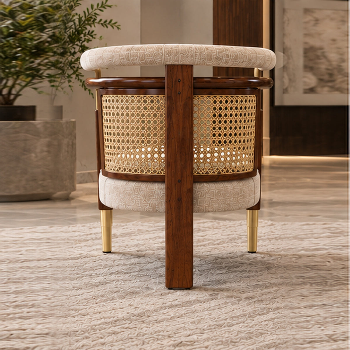 The Heritage Rattan Accent Chair rear view with two front legs and one central wooden rear leg, crisp interior background