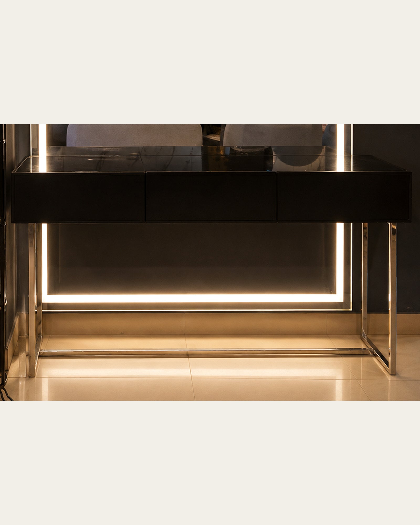 Black drawer console and polished open frame base detail of Luma Frame vanity by Z Galleria