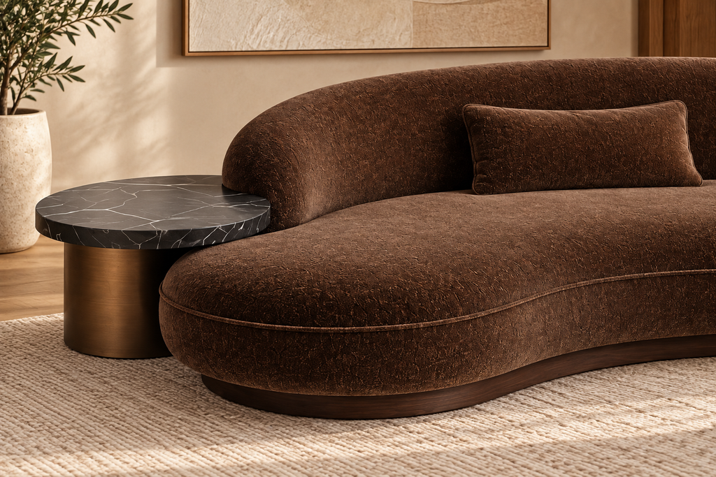Close-up of the Obsidian Pebble sofa’s integrated black marble side table and bronze base