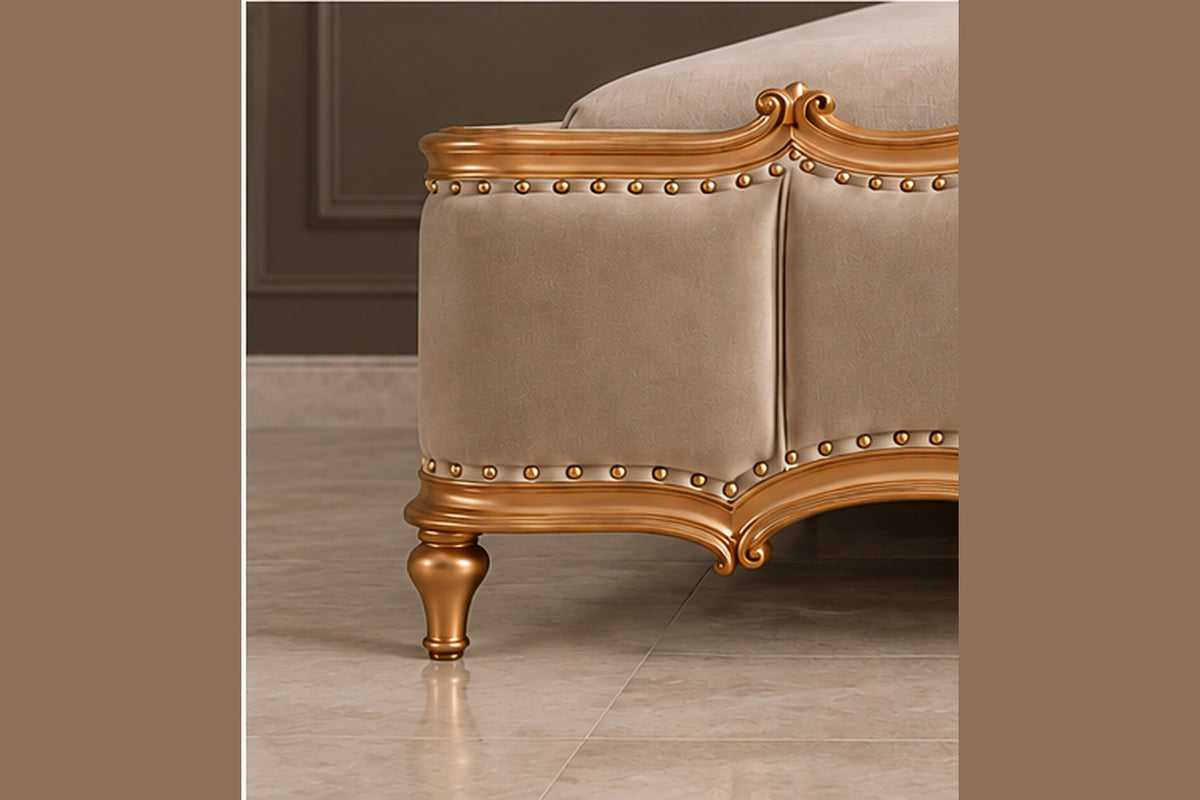 Regalia Crest Bed close-up showing sculpted footboard, gold trim and nailhead detailing